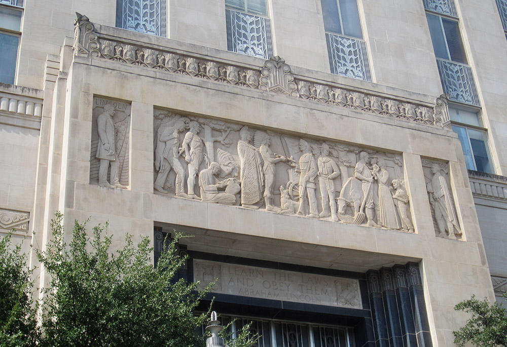 A carved mural depicting Oklahoma history is seen above the main entrance of the Oklahoma County Courthouse in Oklahoma City. A group called the Oklahoma Parent Legislative Action Committee has filed a lawsuit in Oklahoma County District Court, challenging the constitutionality of the planned taxpayer-funded St. Isidore Virtual Catholic Charter School. (Wikimedia Commons/Another Believer)