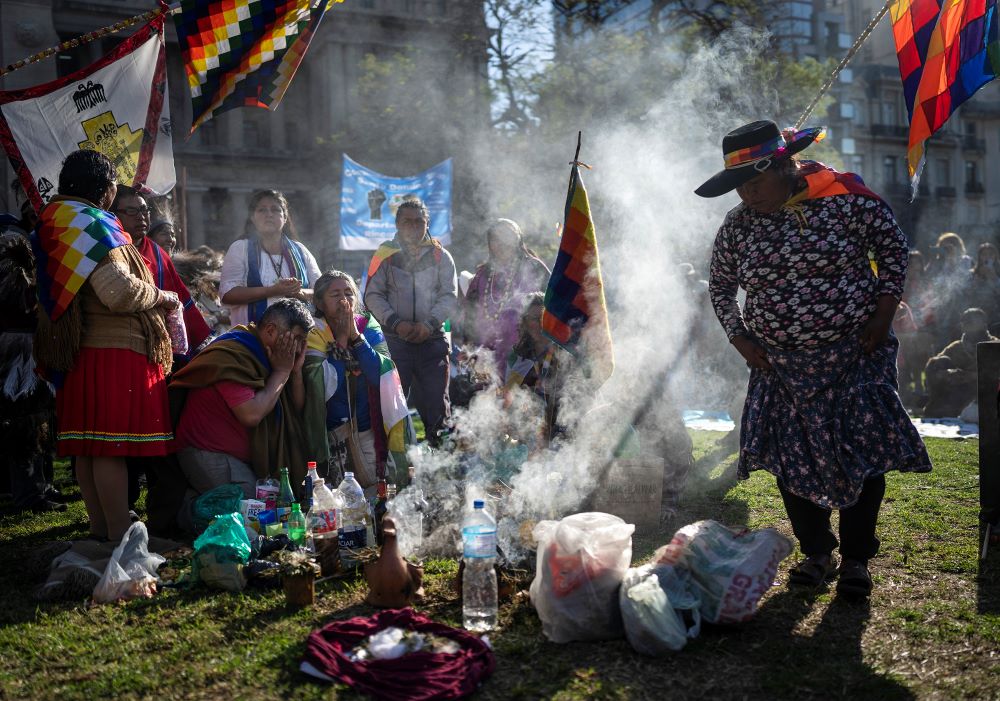 Indigenous leaders from the province of Jujuy perform a ceremony in front of the Palace of Justice during celebrations of "La Pachamama," or Mother Earth Day, in Buenos Aires, Argentina, Tuesday, Aug. 1, 2023. The group's protest, which coincides with La Pachamama, is also directed against a provincial constitutional reform they claim is an attempt against their ancestral rights to lands that the state aims to use for lithium mining. (AP Photo/Rodrigo Abd)