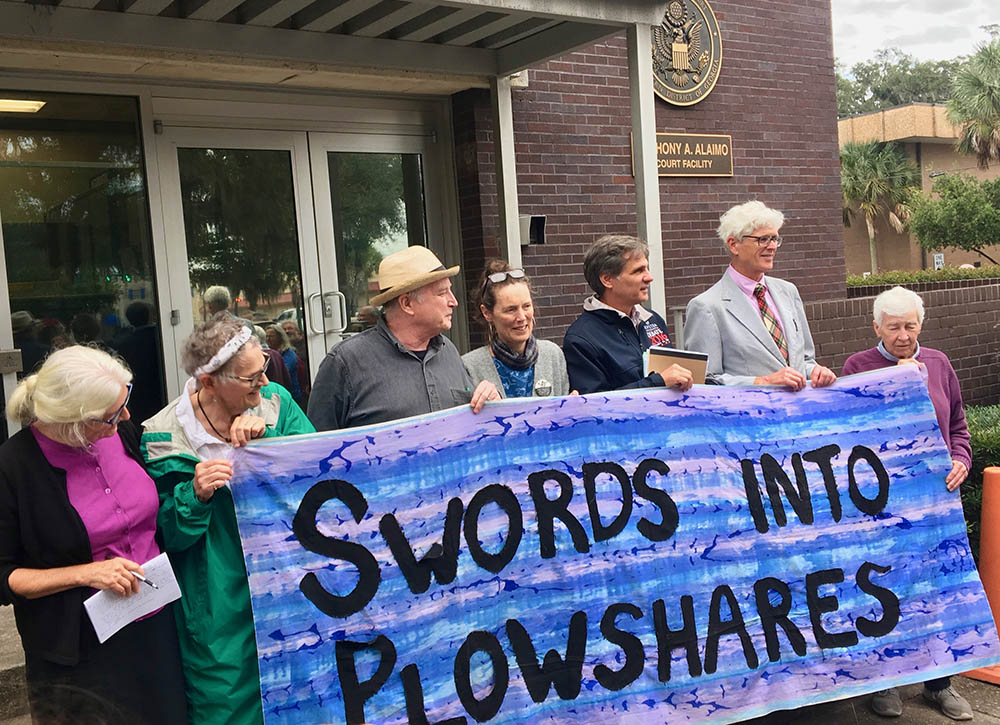 Members of the Kings Bay Plowshares — from left, Martha Hennessy, Mark Colville, Clare Grady, Carmen Trotta, Patrick O'Neill and Liz McAlister — stand outside the U.S. District Courthouse in Brunswick, Georgia, on Oct. 24, 2019, just after the trial on charges related to their 2018 protest against nuclear weapons. (Wikimedia Commons/Bones Donovan)