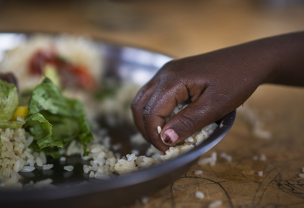 A girl eats at a school Sept. 19, 2022, in Dollow, Somalia. The Famine Early Warning Systems Network predicts that by July, parts of Somalia and eight other countries will be at internationally recognized emergency levels of food insecurity. (AP photo/Jerome Delay, File)