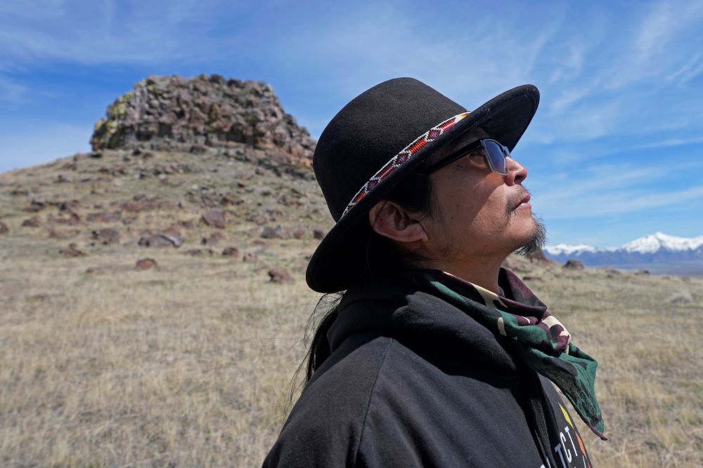 Gary McKinney, a spokesman for People of Red Mountain and a member of the nearby Duck Valley Shoshone-Paiute Tribe, walks near Sentinel Rock on April 25, 2023, outside of Orovada, Nev. The Reno-Sparks Indian Colony is abandoning its 3-year lawsuit aimed at blocking a lithium mine currently under construction at Thacker Pass in northwest Nevada.