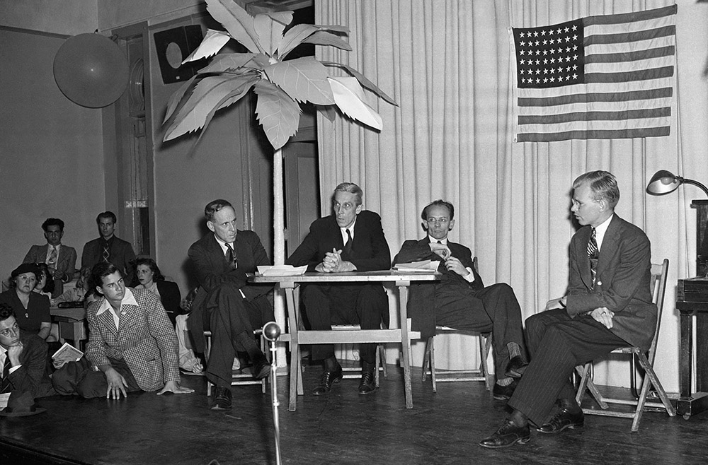 A religious pacifist, the Rev. Francis Hall, right, sits before a test tribunal for conscientious objectors in New York, Sept. 23, 1940. Also onstage from left are Roger Baldwin, director of the American Civil Liberties Union; Evan Thomas, chairman of the War Resisters League; and Herman Reissig. (AP/Anthony Camerano)