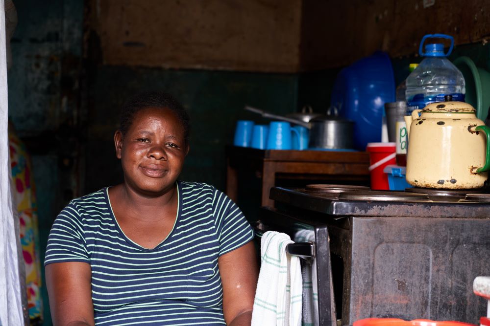 Mary Liawe sits inside her one-room rented apartment in the Matapi hostel in a suburb of Harare, Zimbabwe.