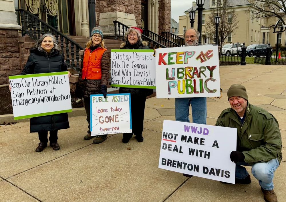 Members of Keep Our Library Public protest outside St. Peter Cathedral in Erie, Pennsylvania, on Dec. 10.