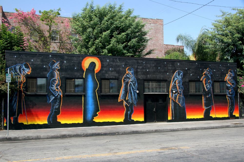 In 1990, Gary Palmatier painted the “Jesus of the Bread Line” mural, an interpretation of an etching by Fritz Eichenberg, on a wall of the Catholic Worker soup kitchen in Los Angeles. (Mike Wisniewski)