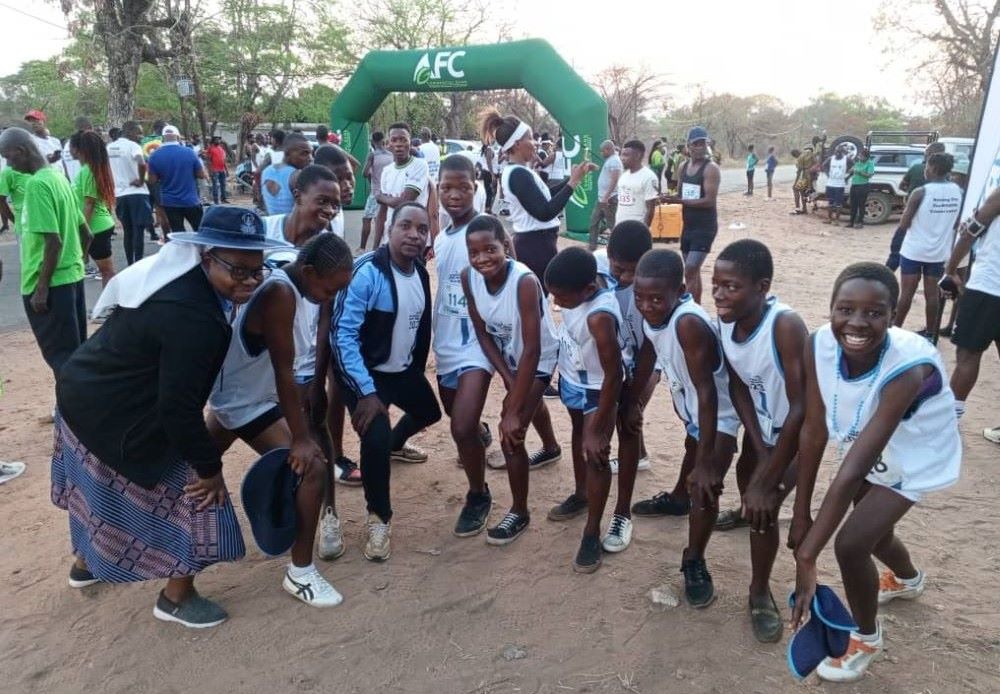 AMR Sr. Grace Moyo, a teacher at the AMR Secondary School in Lupane, Zimbabwe, poses with participants in the Binga Kasambabezi Marathon. AMR sisters organized their students to take part in the Oct. 21, 2023, race, whose theme was "Running for our wildlife conservation" as part of efforts to educate young people about the environment. (Courtesy of AMR)