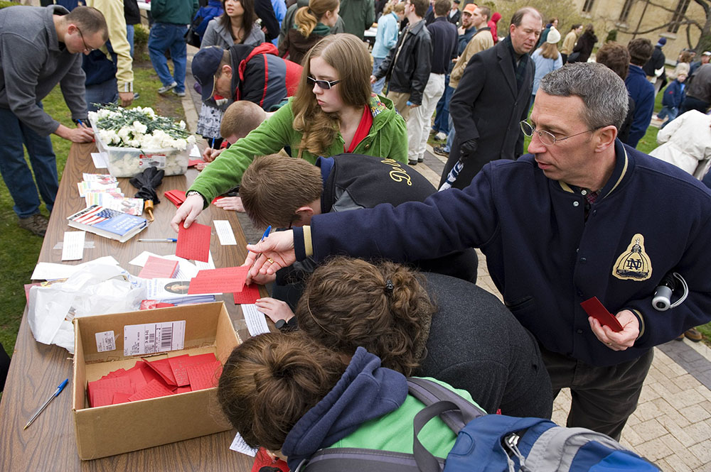 Chicago resident and Notre Dame alumnus Jeff Heinz, right, drops his handwritten letter to University of Notre Dame President Holy Cross Fr. John Jenkins into a box April 5, 2009, during a rally at the university in Notre Dame, Indiana. Hundreds of anti-abortion advocates protested on the campus against the school's invitation to President Barack Obama to speak at the May 17 graduation ceremony that year. (CNS/Jon L. Hendricks)