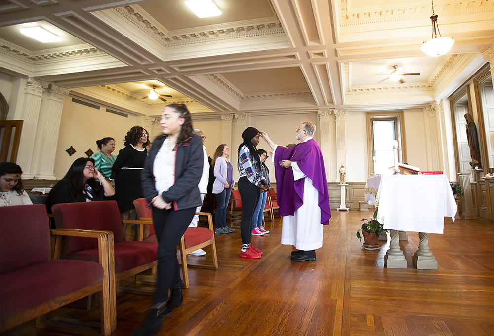 Paulist Fr. Rich Colgan distributes ashes during Ash Wednesday Mass at Trinity Washington University Feb. 26, 2020. Paulists serve in nine U.S. states and the District of Columbia, primarily at parishes, college centers, and through various ministries, programs and offices. (CNS/Tyler Orsburn)