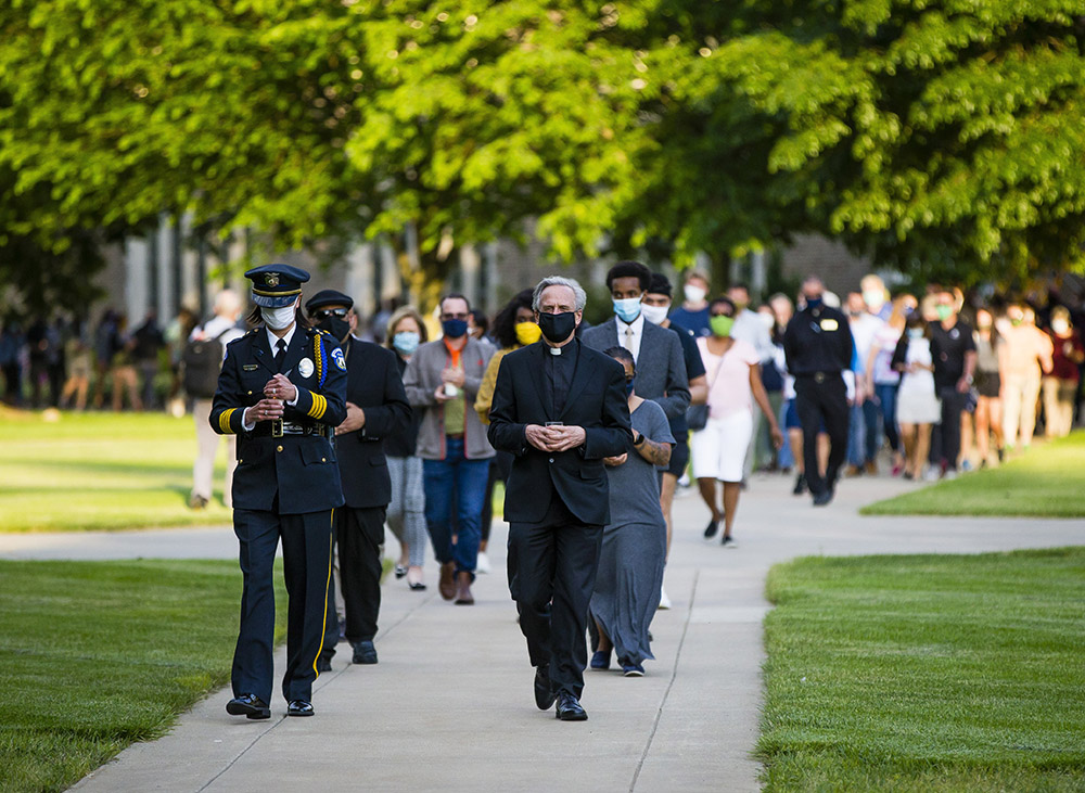 Keri Kei Shibata, director of University Police, and Holy Cross Fr. John Jenkins, president of the University of Notre Dame in Indiana, lead guests to the Grotto June 1, 2020, during the "Pray for Unity, Walk for Justice" event in memory of George Floyd on the campus near South Bend. (CNS/South Bend Tribune via Reuters/Michael Caterina)