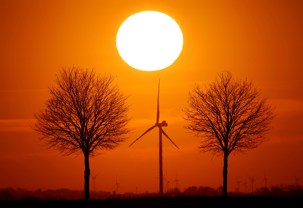 Windmill turbines are seen in this illustration photo. Since the U.S. church owns nearly 100,000 buildings, Catholic decarbonization could shift local energy markets and show society the morality of decarbonization. (CNS/Reuters/Pascal Rossignol)