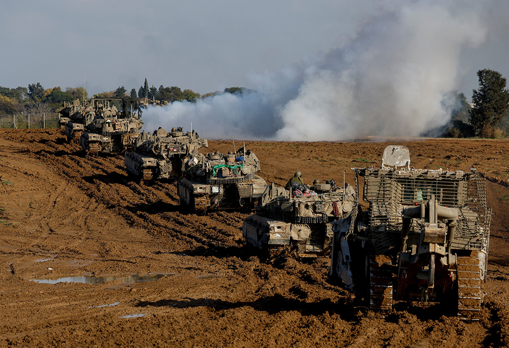 Israeli military vehicles move out of the Gaza Strip, as seen from southern Israel Jan. 15, 2024, amid the ongoing conflict between Israel and the Palestinian Islamist group Hamas. (OSV News/Reuters/Amir Cohen)