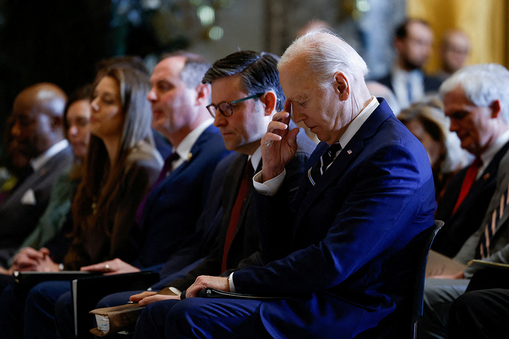 U.S. President Joe Biden pauses as he sits alongside House Speaker Mike Johnson, R-Louisiana, during the annual National Prayer Breakfast at the U.S. Capitol in Washington Feb. 1, 2024. (OSV News/Reuters/Evelyn Hockstein)