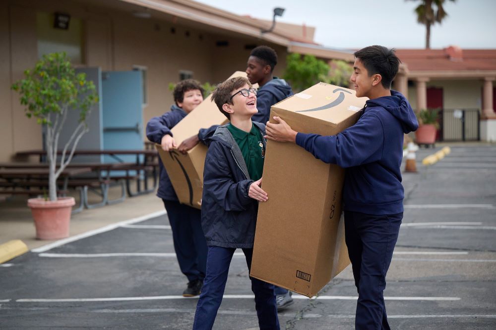 St. John of the Cross School students in Lemon Grove, Calif., move boxes into St. Michael Academy in San Diego Feb. 5, 2024, after their campus sustained severe flooding in a historic rainstorm Jan. 22. St. Michael Academy closed three years ago. (OSV News photo/Andy Hayt, The Southern Cross)