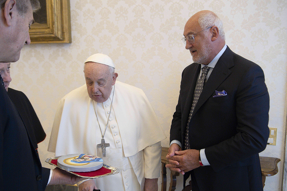 Bruno Abate, founder and president of Recipe for Change, gives Pope Francis a painting of Mary and the child Jesus made by an inmate at Chicago's Cook County Jail during a meeting in the library of the Apostolic Palace at the Vatican Feb. 9, 2024. (CNS/Vatican Media)