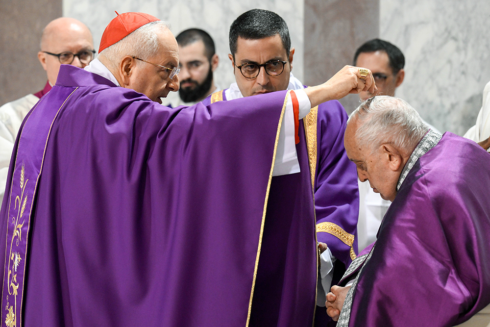 Cardinal Mauro Piacenza, head of the Apostolic Penitentiary, sprinkles ashes on Pope Francis' head during Ash Wednesday Mass at the Basilica of Santa Sabina in Rome Feb. 14, 2024. (CNS/Vatican Media)
