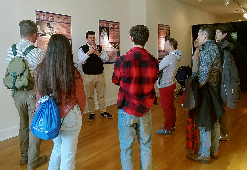 Attendees at the 2024 New York Encounter, a Feb. 16-18 event organized by the Catholic lay movement Communion and Liberation, take a guided tour of one of the exhibitions. (Jeannine Pitas)