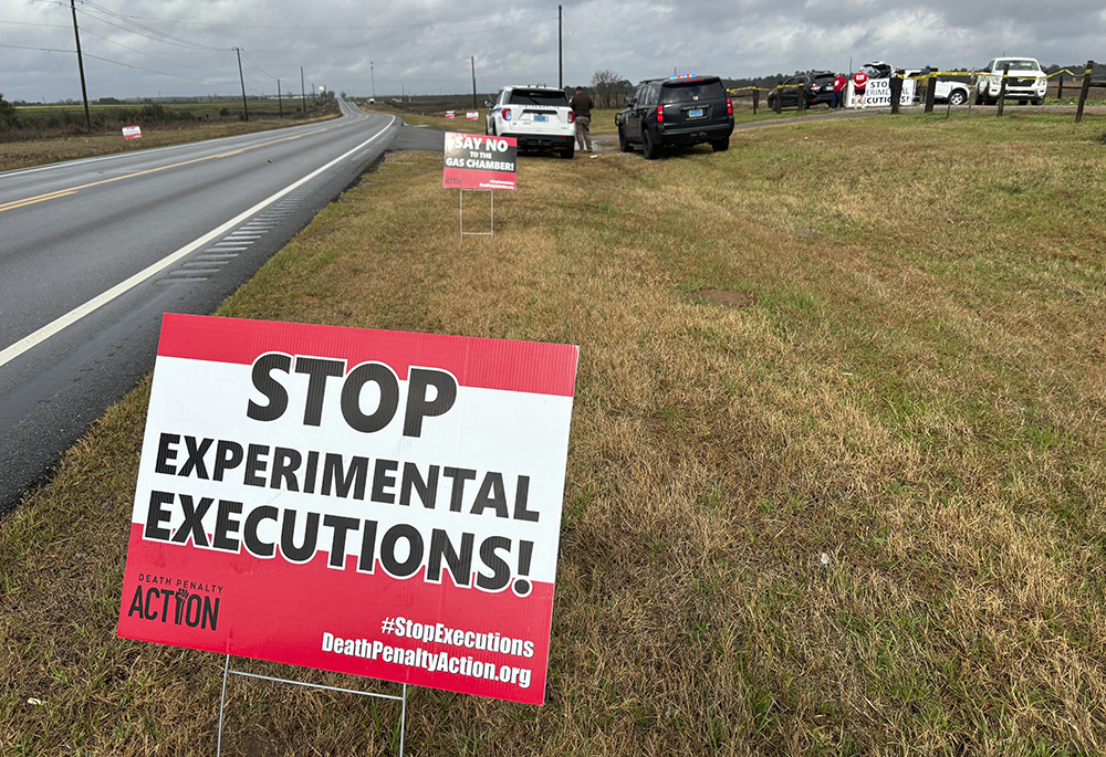 Anti-death penalty activists place signs along the road heading to Holman Correctional Facility in Atmore, Alabama, ahead of the scheduled execution of Kenneth Smith on Jan. 25. The state put Smith to death with nitrogen gas, the first time the new method has been used in the United States. (AP photo/Kim Chandler)
