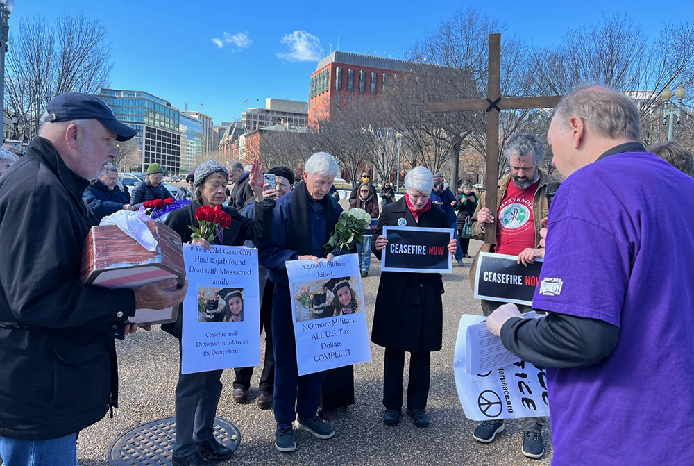 Attendees pray during a cease-fire demonstration near the White House in Washington, Feb. 14, 2024. (RNS/Aleja Hertzler-McCain)