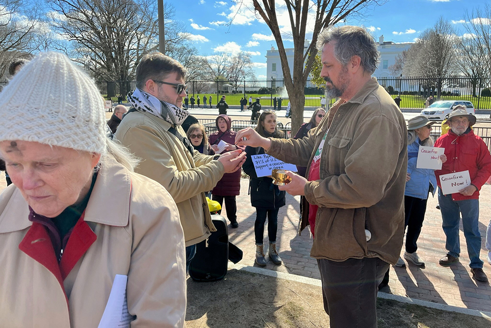 Catholics receive Communion during an Ash Wednesday Mass near the White House in Washington, Feb. 14, 2024. (RNS /Aleja Hertzler-McCain)