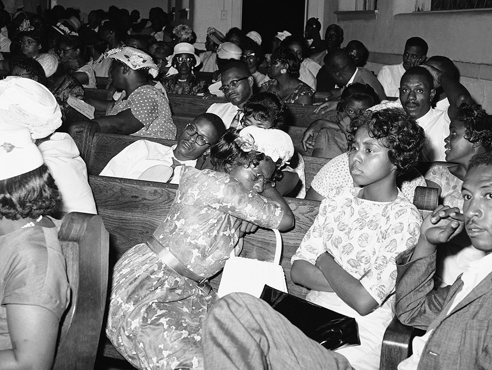 People get comfortable in the pews of First Baptist Church on May 23, 1961, in Montgomery, Alabama, as they wait for their own safety to leave an integration rally. White segregationists rioted around the church that night. (AP/Horace Cort)