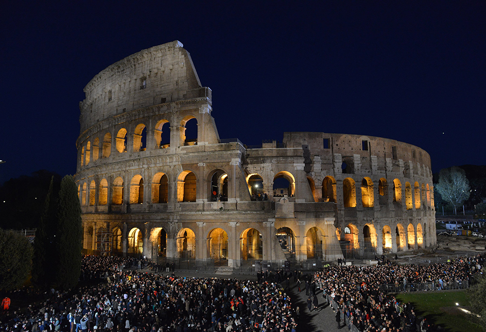 Crowds gather at Rome's Colosseum for the nighttime Way of the Cross service on Good Friday, April 7, 2023. Released from the hospital just five days before Good Friday 2023, Pope Francis did not go to the Colosseum. (CNS/Chris Warde-Jones)