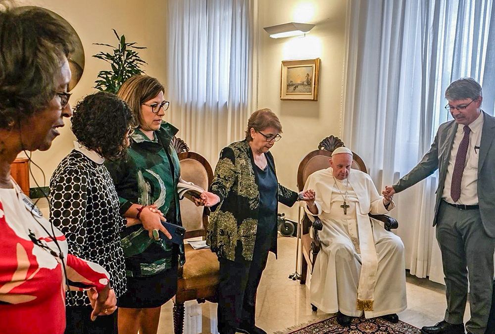 Pope Francis prays with delegates from community organizing groups that are affiliated with the West/Southwest Industrial Areas Foundation, which includes Texas IAF, after a private meeting in his Vatican residence, the Domus Sanctae Marthae, Sept. 14, 2023. (CNS/Courtesy of West/Southwest Industrial Areas Foundation)