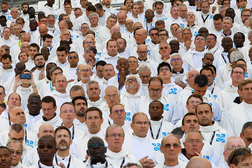 Concelebrating priests pray as Pope Francis presides over Mass at the Vélodrome Stadium in Marseille, France, Sept. 23, 2023. (CNS/Lola Gomez)