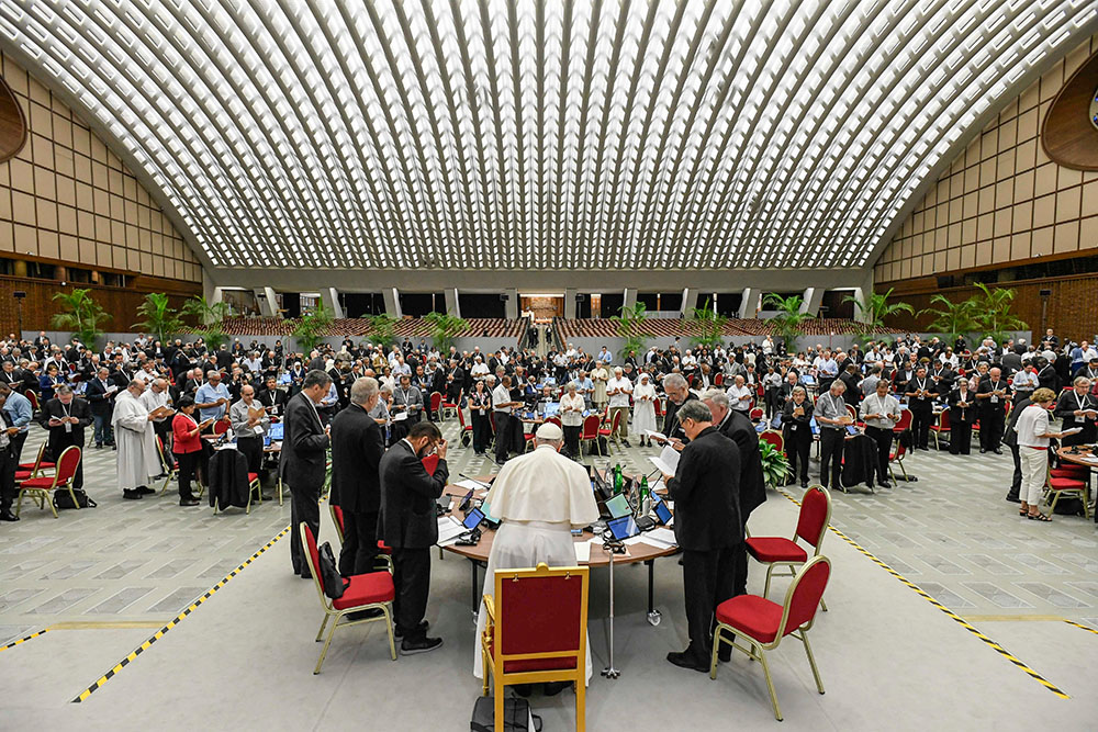Pope Francis and members of the assembly of the Synod of Bishops begin their work with prayer Oct. 20, 2023, in the Paul VI Audience Hall at the Vatican. (CNS/Vatican Media)