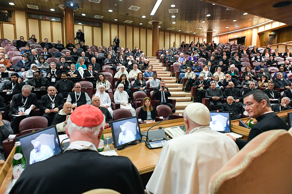 Pope Francis, seated next to Cardinal Marc Ouellet, president of the Center for Research and Anthropology of Vocations and retired prefect of the Dicastery for Bishops, speaks at an international congress titled, "Man-Woman: Image of God. For an Anthropology of Vocations," in the Synod Hall at the Vatican March 1, 2024. (CNS/Vatican Media)