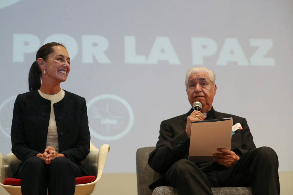 Claudia Sheinbaum and Archbishop Rogelio Cabrera López of Monterrey Presidential candidate Claudia Sheinbaum of Mexico's ruling party smiles as Archbishop Rogelio Cabrera López of Monterrey speaks March 11, 2024, during an event in Mexico City to sign a peace commitment organized by members of the Catholic Church.