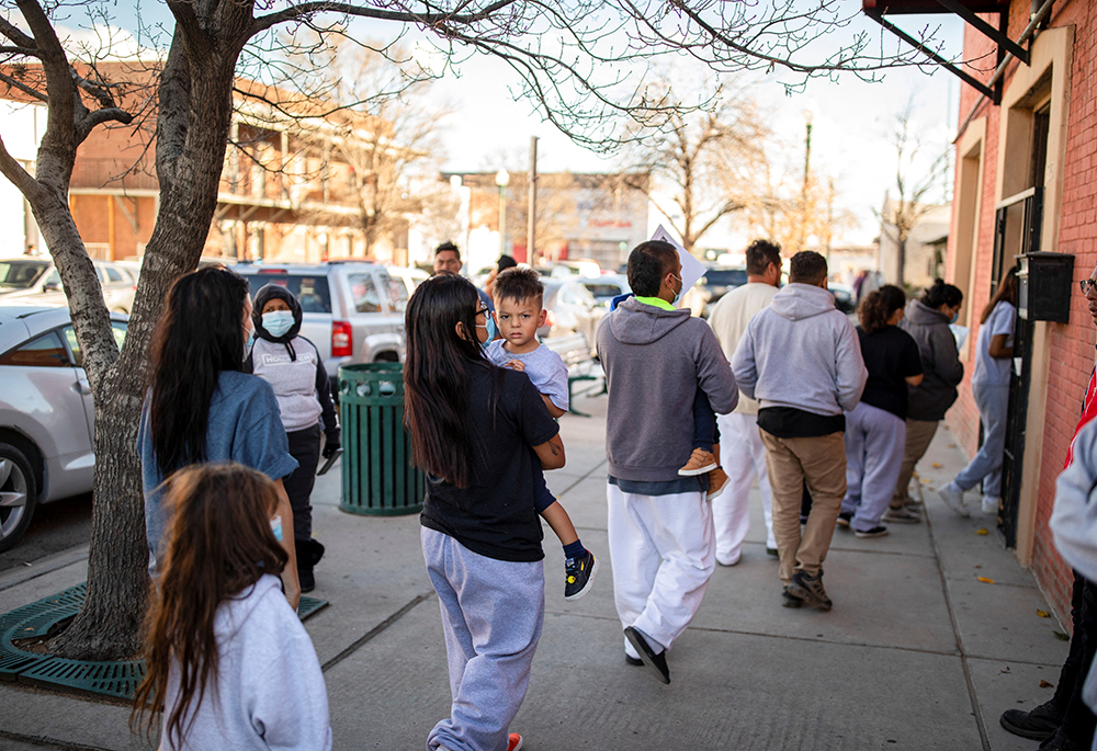 A family of migrants is dropped off by a transport contractor for the U.S. Customs and Border Protection at a shelter run by Annunciation House  Dec. 13, 2022, in downtown El Paso, Texas. A state judge blocked the Texas attorney general's demands for the records of Annunciation House March 11, 2024, citing concerns the state had a "predetermined" motive to shut down the Catholic nonprofit serving migrants. (OSV News/Reuters/Ivan Pierre Aguirre)