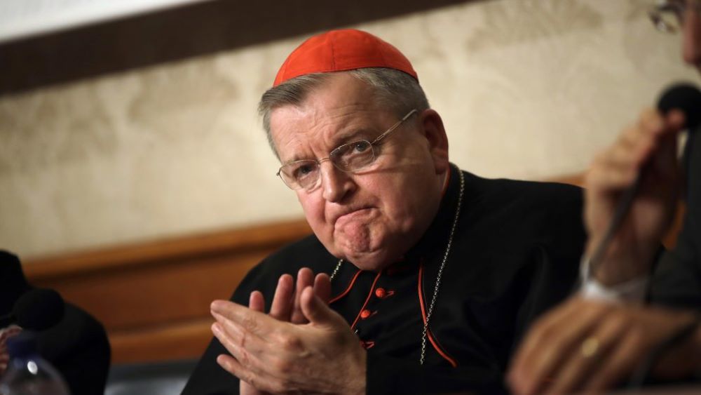 Cardinal Raymond Burke applauds during a news conference at the Italian Senate on Sept. 6, 2018.