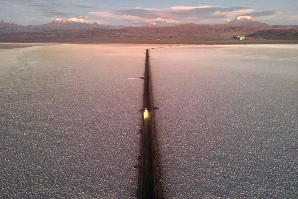 A car drives down a road through the Salar de Atacama salt flat near the Albemarle lithium mine in Chile, on April 17, 2023. 