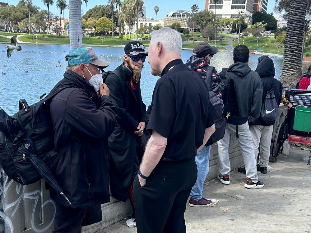 LA Auxiliary Bishop Matthew Elshoff talks with guests waiting for Feed My Poor's meals.