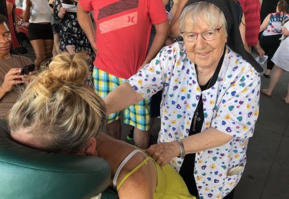 Sr. Rosalind Gefre gives a therapeutic massage in 2018 at a St. Paul Saints minor league baseball game.