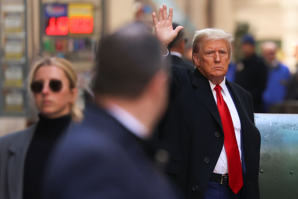 Former President Donald Trump motions as he departs 40 Wall Street in New York City after a news conference, March 25, in New York.