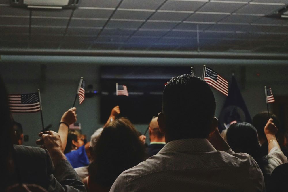 People hold small American flags