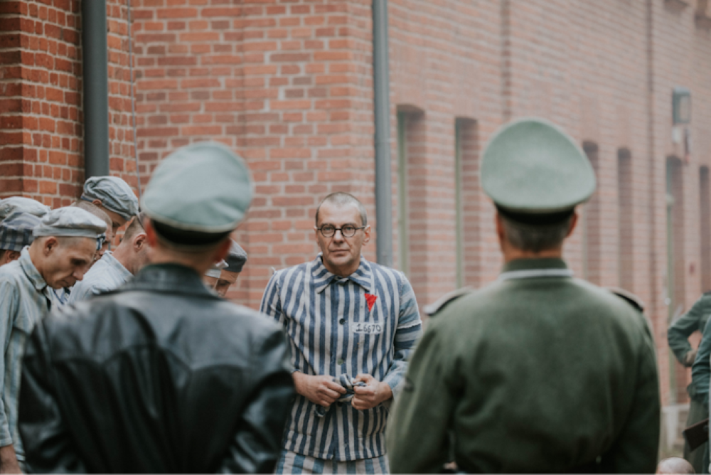 The Polish priest Maximillian Kolbe, portrayed by Marcin Kwasny, enters Auschwitz concentration camp in a scene from the forthcoming film, "Triumph of the Heart."