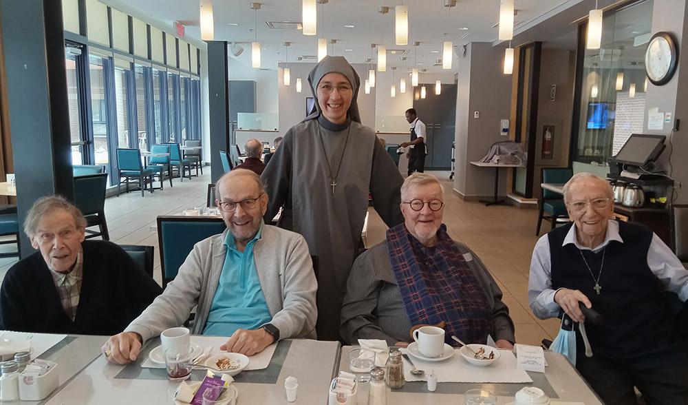 Mater Dei Sr. Natalia Vazquez joins senior priests during lunchtime at the Angus residence in Montreal. (Courtesy of Natalia Vazquez)