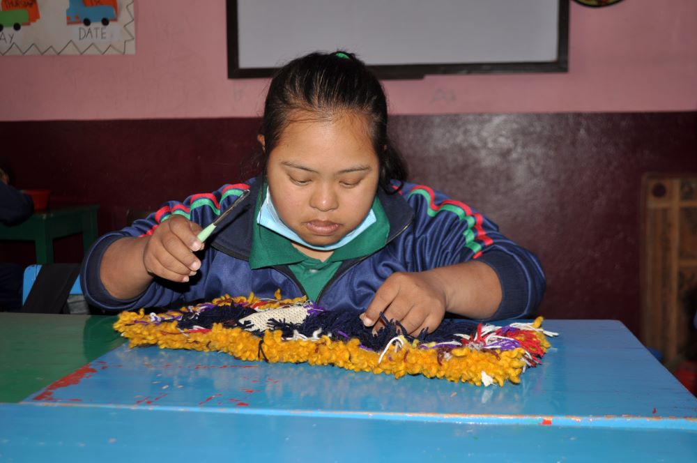 A student makes a mat at the vocational class at Navjyoti Centre, in Kathmandu, Nepal.