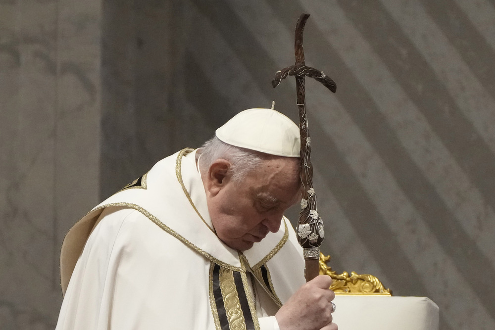 Pope Francis, Holy Thursday Chrism Mass. Pope Francis leans head on processional crucifix.