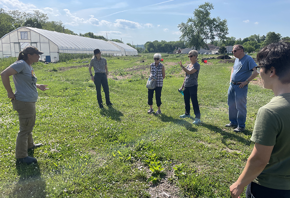 Members of the All Saints Church environmental task force discuss the management of their native plants garden in Syracuse, New York, in summer 2023. (Courtesy of Michael Songer)