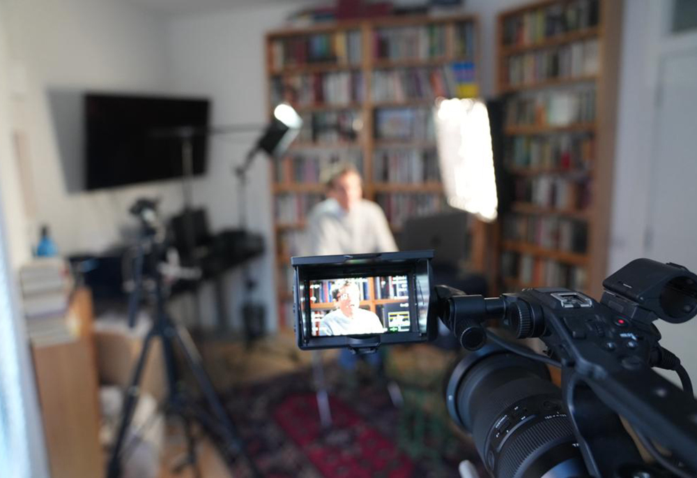 Neve Gordon is pictured in front of a video setup. While he returns to Israel to visit aging parents, he said he and his partner have paid a price. "Our jobs aren't as good. I'm away from my family, from my culture, from my language. So it is a kind of self-imposed exile." (Courtesy of Neve Gordon)