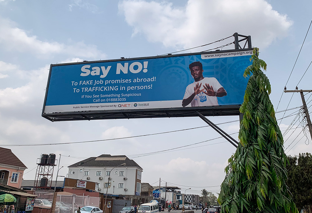 An anti-human trafficking billboard in Lagos, Nigeria, warns the public about fake job offers used by traffickers to lure members of the public into human trafficking. (Valentine Benjamin)