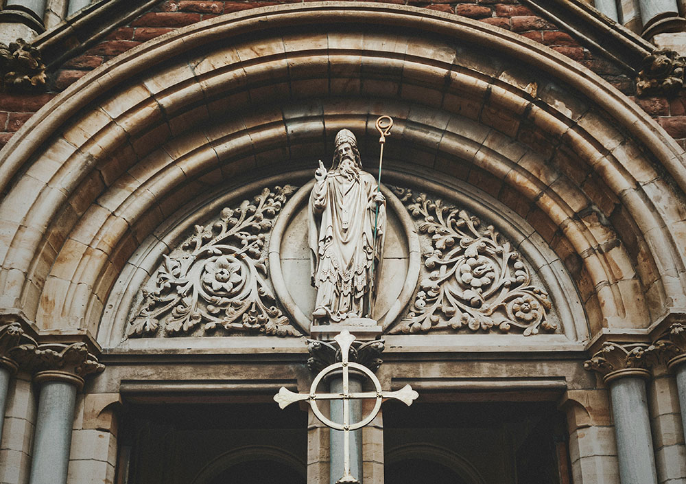 A statue of St. Patrick above the entrance to St. Patrick's Roman Catholic Church in Belfast's Cathedral Quarter in County Antrim, Northern Ireland (Unsplash/K. Mitch Hodge)