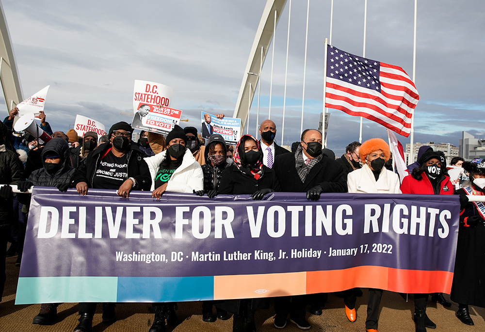 Martin Luther King III, the eldest son of late civil rights activist the Rev. Martin Luther King Jr., and his family take part in a Peace Walk on the Frederick Douglass Memorial Bridge in Washington Jan. 17, 2022, to urge Democrats to pass a law protecting voting rights. (CNS/Reuters/Elizabeth Frantz)