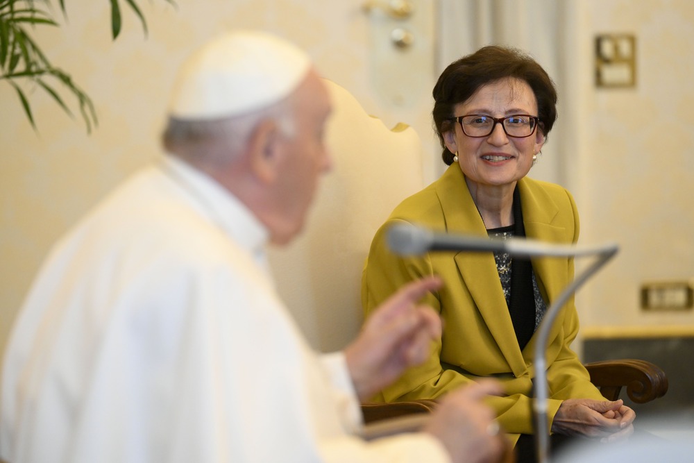 Pope Francis seated in foreground; in-focus is Sr. Nuria Calduch-Benages.