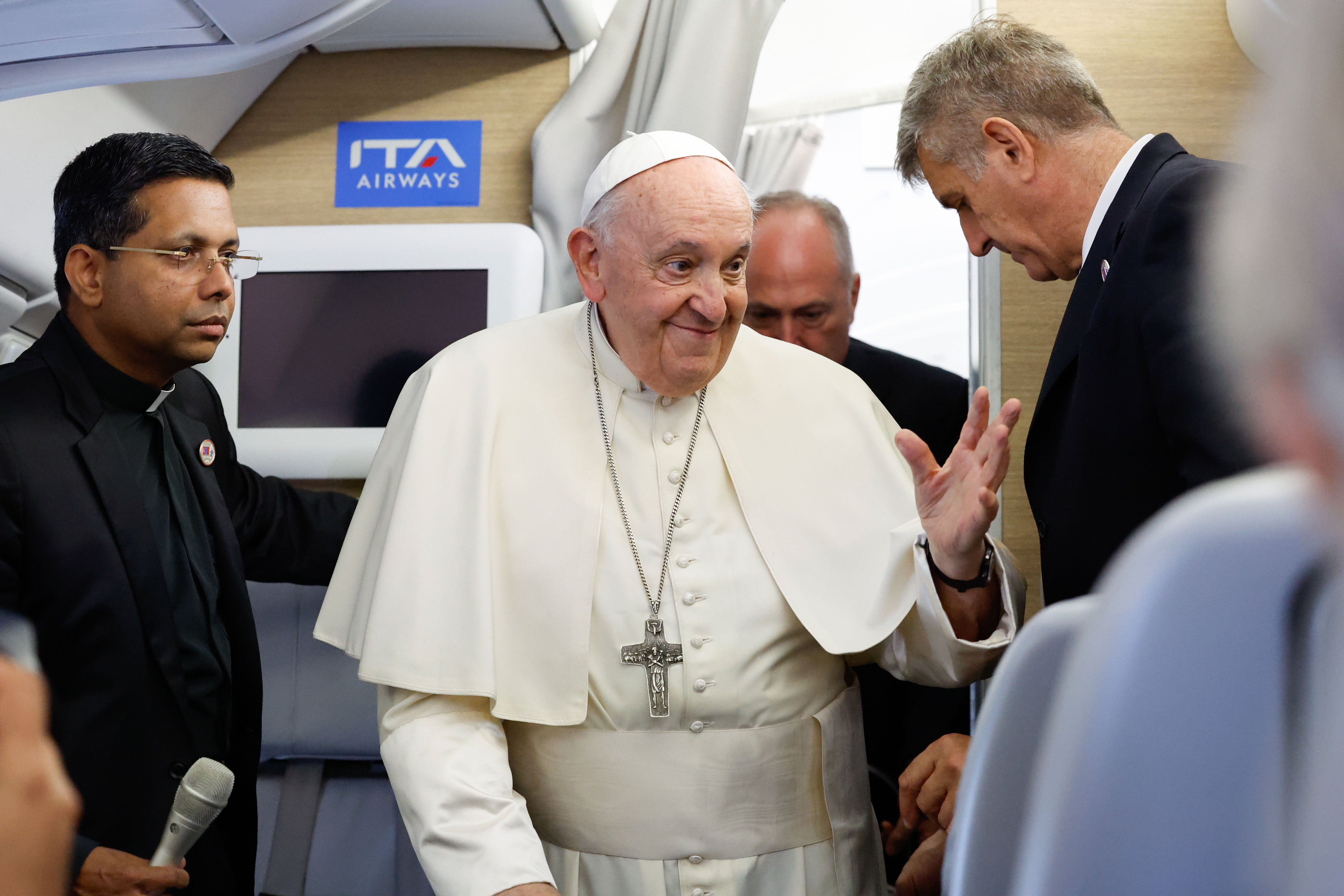 Pope Francis greets journalists aboard his flight back to Rome from Ulaanbaatar, Mongolia, Sept. 4, 2023, after his four-day visit to the Asian country. (CNS photo/Lola Gomez)
