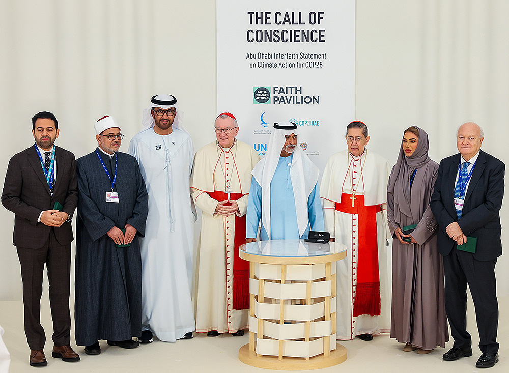 Cardinal Pietro Parolin (fourth from left), Vatican secretary of state, poses for a group photo next to Sultan Ahmed al-Jaber (third from left), the president-designate of COP28; Sheikh Nahyan bin Mubarak Al Nahyan (center), the UAE minister of tolerance and coexistence; and Cardinal Miguel Ángel Ayuso (third from right), prefect of the Dicastery for Interreligious Dialogue, along with other representatives at the inauguration of the Faith Pavilion during the U.N. Climate Change Conference, or COP28.