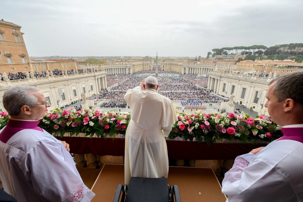 View from behind Pope Francis, as he waves over St. Peter's Square